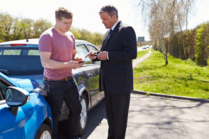 businessman making phone calls after traffic accident